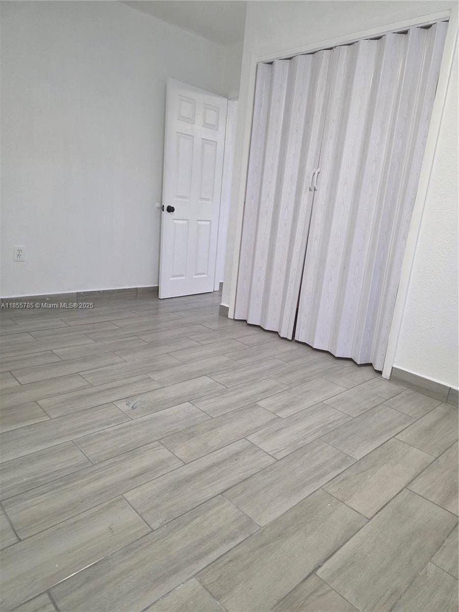 359 West 12th Street, Unit 2 Hialeah, FL 33010 - Photo 4 of 20 a view of a room with wooden floor