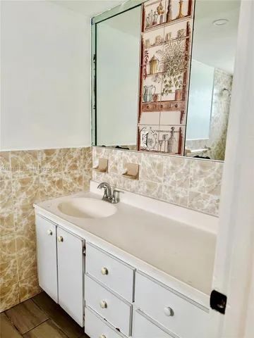 a bathroom with a sink and a mirror