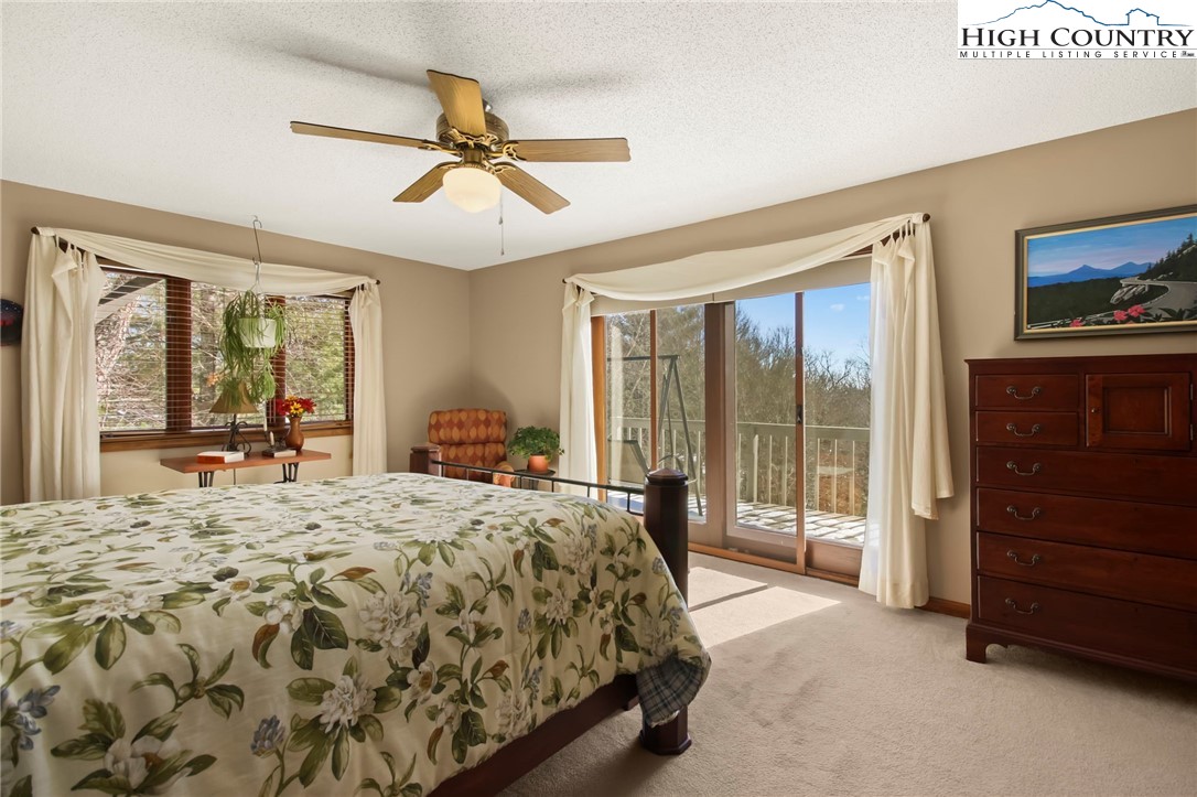 454 Huckleberry Trail Boone, NC 28607 - Photo 13 of 36 a bedroom with a bed and a dresser