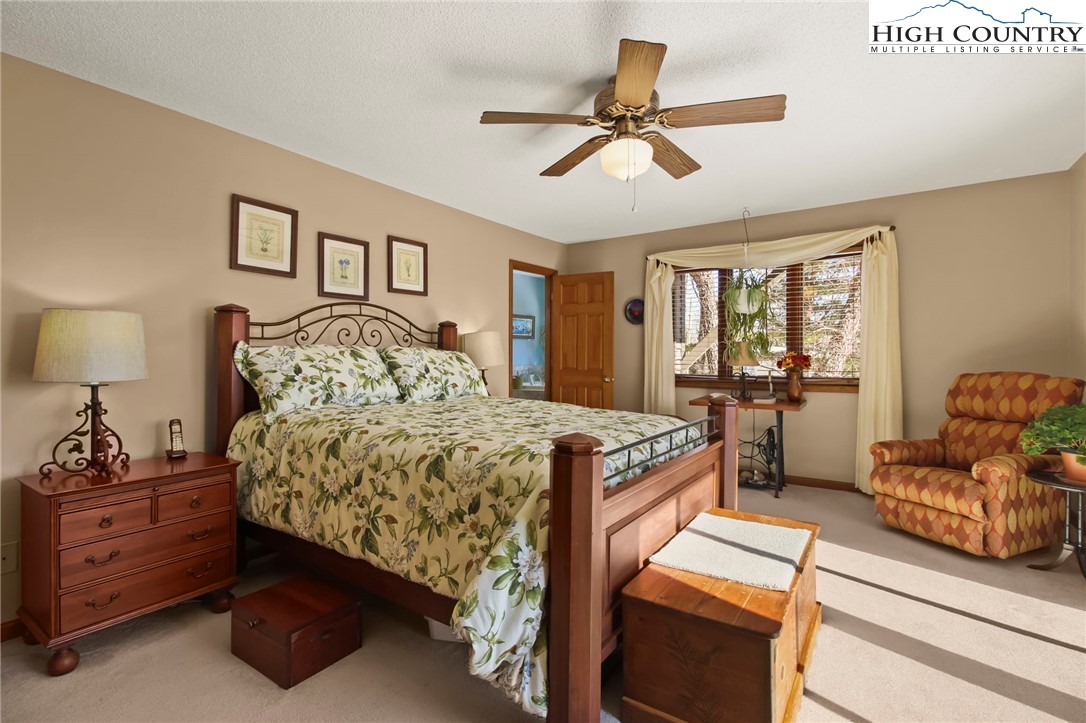 454 Huckleberry Trail Boone, NC 28607 - Photo 15 of 36 a bed room with a bed and a couch