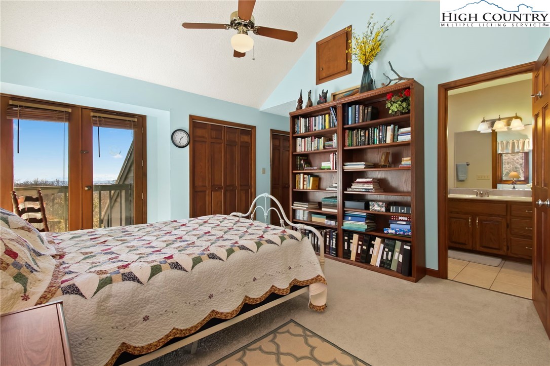 454 Huckleberry Trail Boone, NC 28607 - Photo 23 of 36 a bedroom with a bed furniture and a window