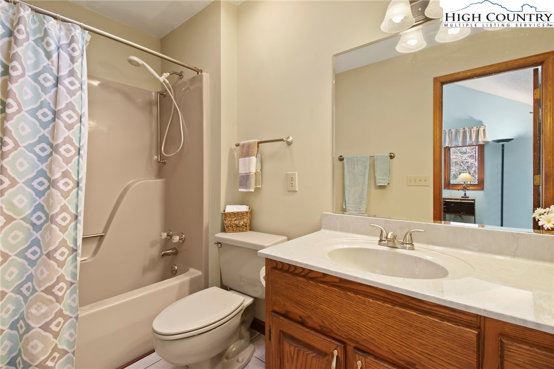 454 Huckleberry Trail Boone, NC 28607 - Photo 24 of 36 a bathroom with a sink toilet and shower