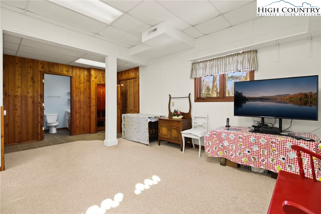 454 Huckleberry Trail Boone, NC 28607 - Photo 29 of 36 a bedroom with furniture and a flat screen tv