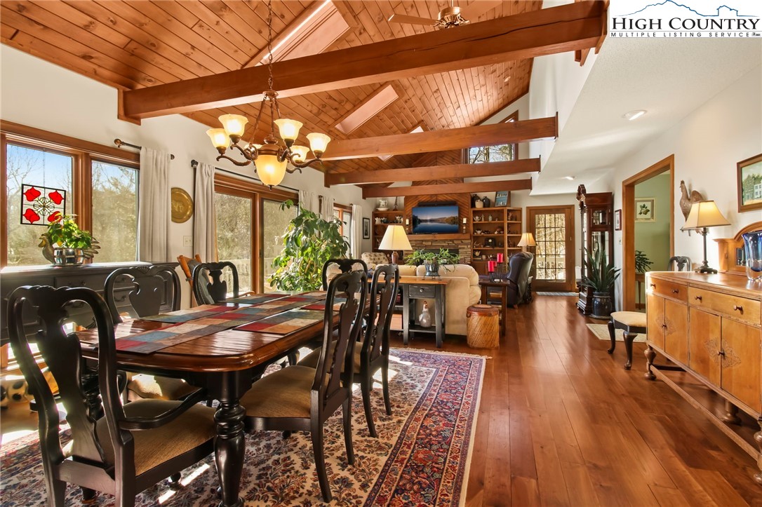 454 Huckleberry Trail Boone, NC 28607 - Photo 3 of 36 a view of a dining room with furniture and wooden floor