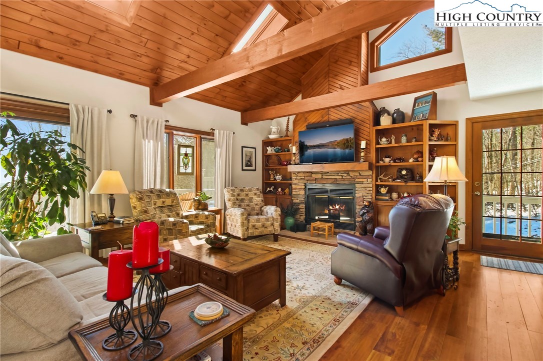 454 Huckleberry Trail Boone, NC 28607 - Photo 5 of 36 a living room with fireplace furniture and a large window