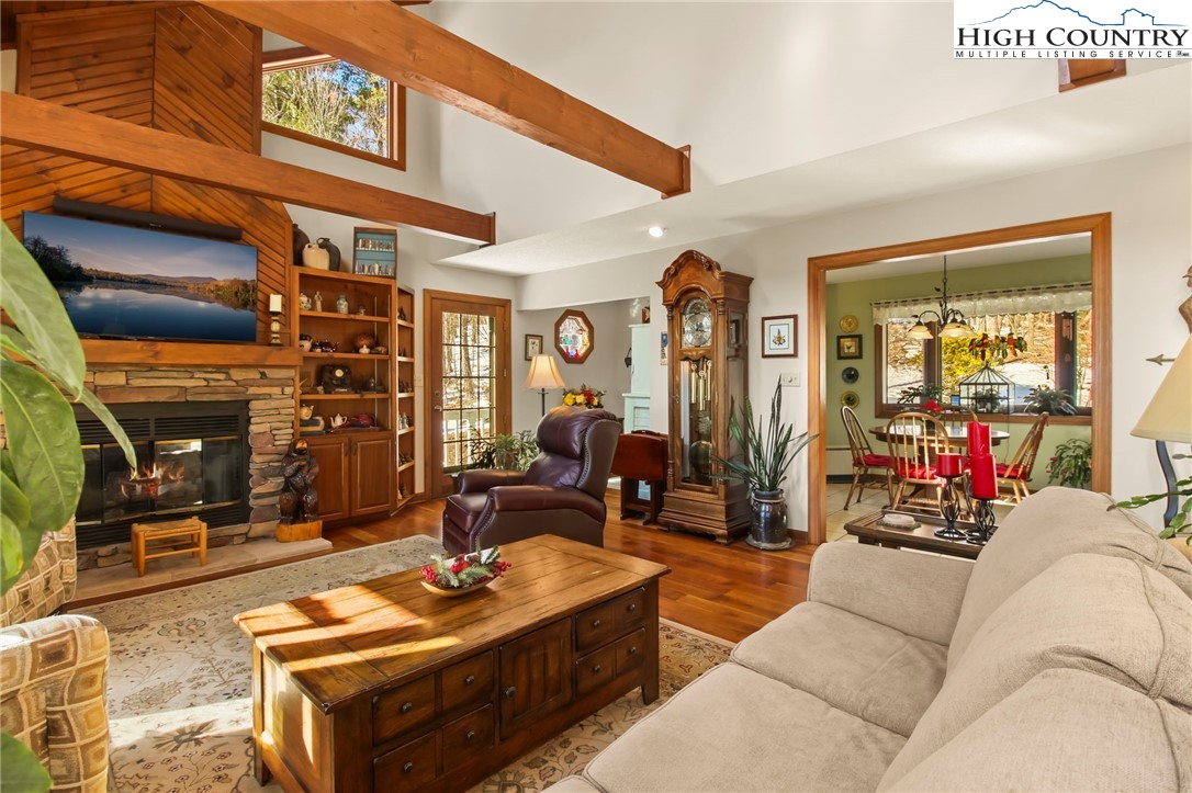 454 Huckleberry Trail Boone, NC 28607 - Photo 6 of 36 a living room with furniture a fireplace and a projector