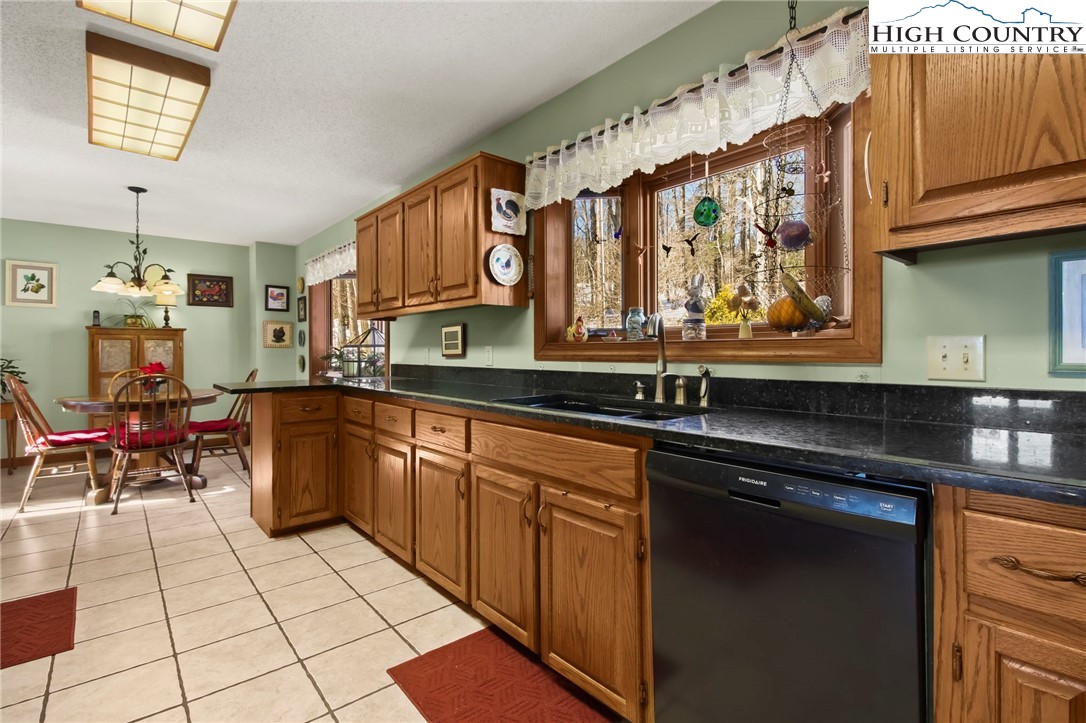 454 Huckleberry Trail Boone, NC 28607 - Photo 10 of 36 a kitchen with stainless steel appliances granite countertop a sink and cabinets