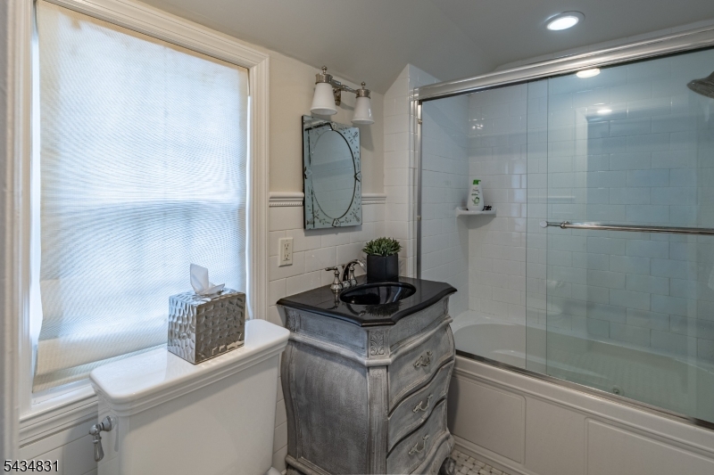 200 Wychwood Road Westfield, NJ 07090 - Photo 17 of 31 a bathroom with a granite countertop sink a toilet and shower