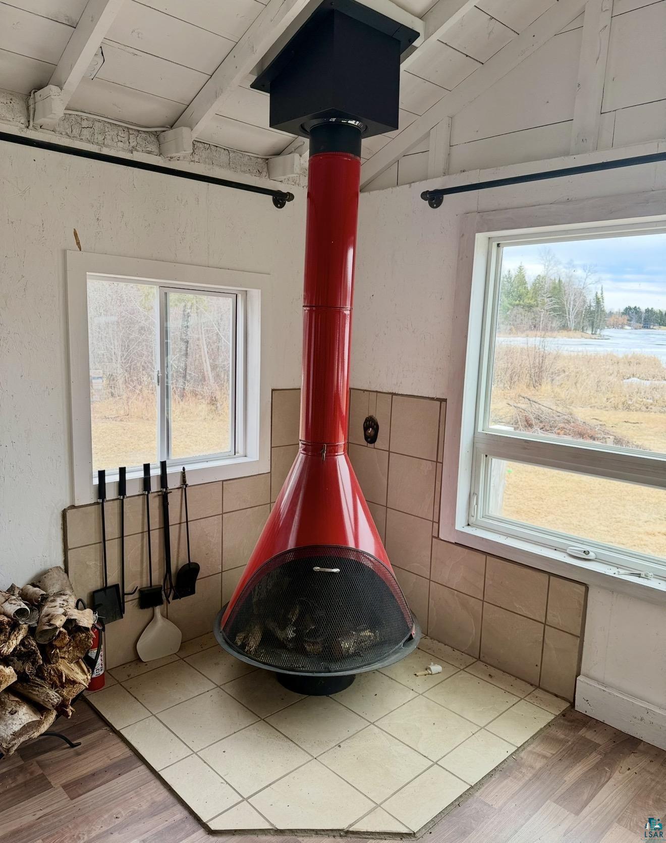 9572 Bonner Road Mountain Iron, MN 55768 - Photo 3 of 20 Detailed view of a wood stove, wood finished floors, and wooden ceiling