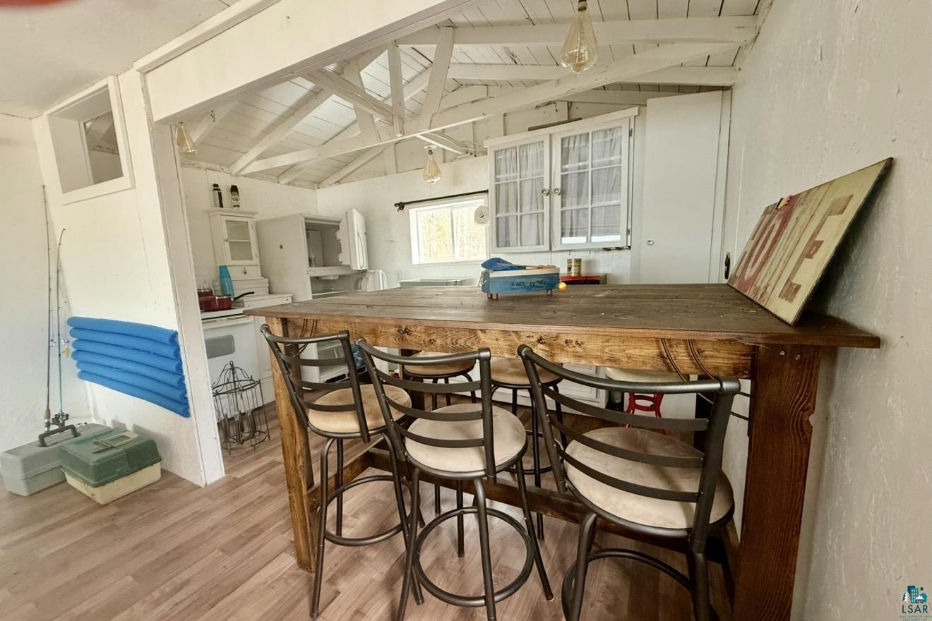 9572 Bonner Road Mountain Iron, MN 55768 - Photo 7 of 20 Bar area with light wood-type flooring, wooden counters, white cabinets, glass insert cabinets, and white electric range oven