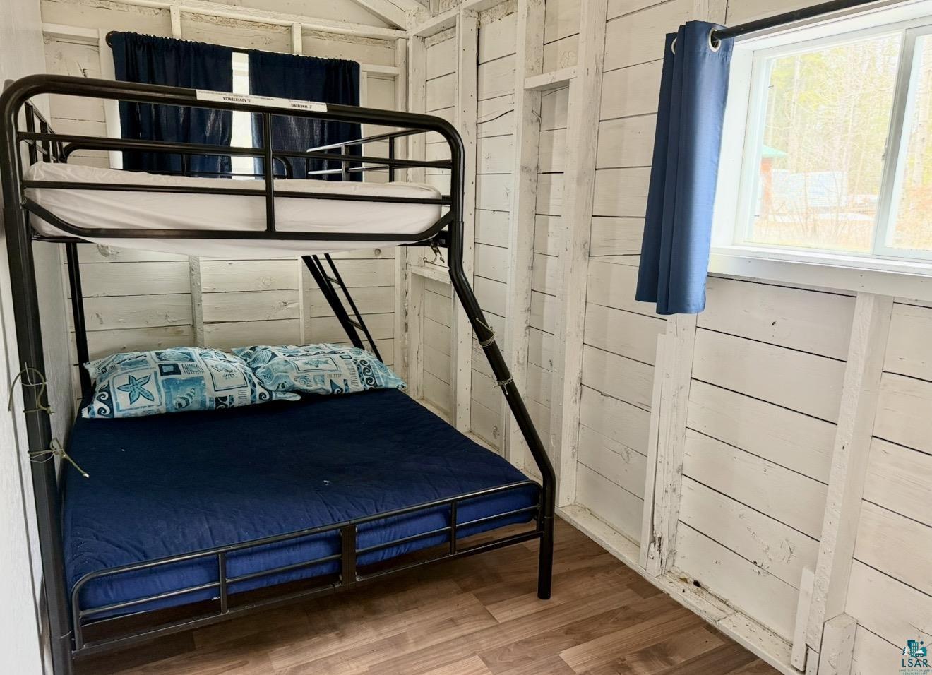9572 Bonner Road Mountain Iron, MN 55768 - Photo 10 of 20 Bedroom featuring wood walls and wood finished floors