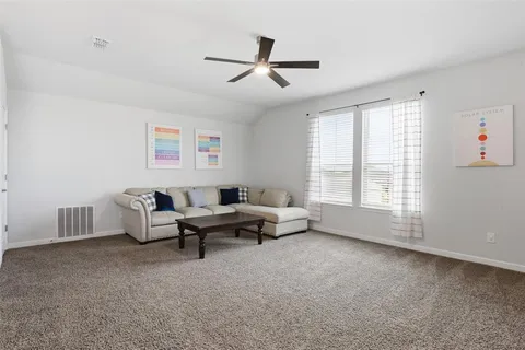 a living room with furniture and windows