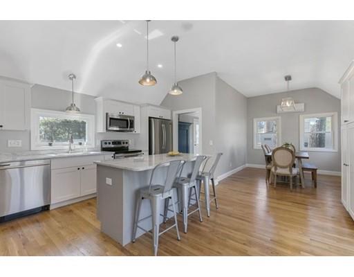 2 Abbott Road Natick, MA 01760 - Photo 6 of 23 a kitchen with stainless steel appliances kitchen island granite countertop a table chairs sink and cabinets