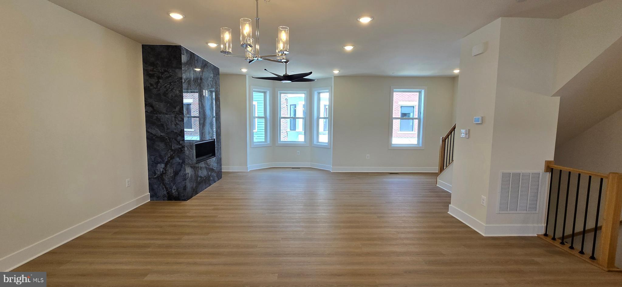 416 Chapel Alley, Unit 3 Frederick, MD 21701 - Photo 11 of 41 an empty room with wooden floor and windows