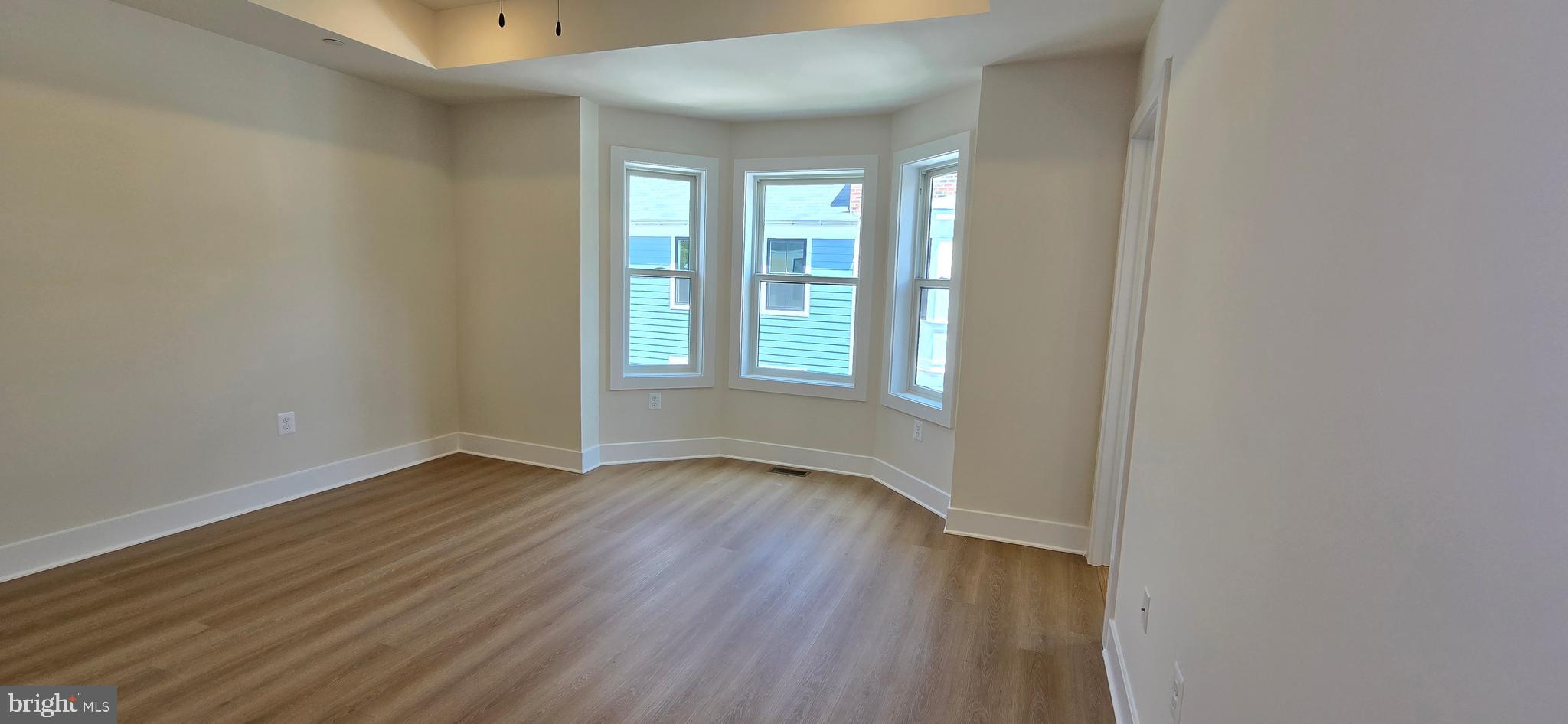 416 Chapel Alley, Unit 3 Frederick, MD 21701 - Photo 22 of 41 an empty room with wooden floor and windows