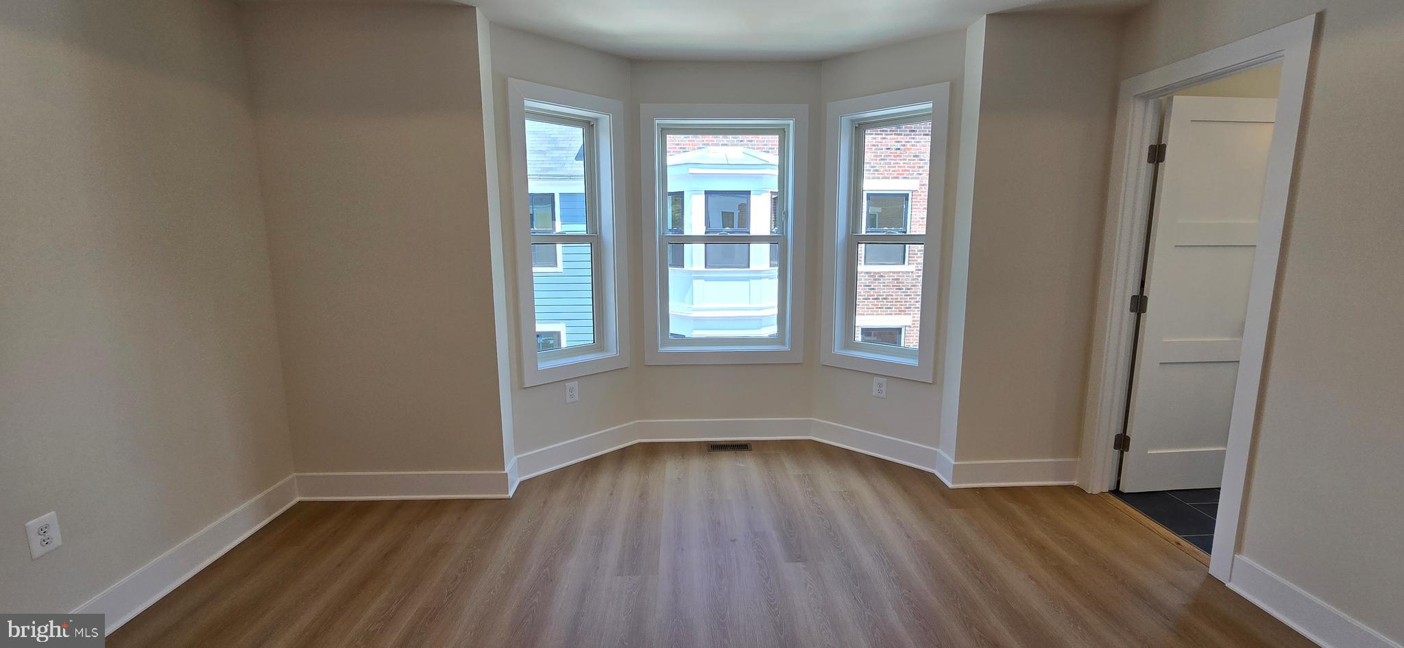 416 Chapel Alley, Unit 3 Frederick, MD 21701 - Photo 23 of 41 an empty room with wooden floor and windows