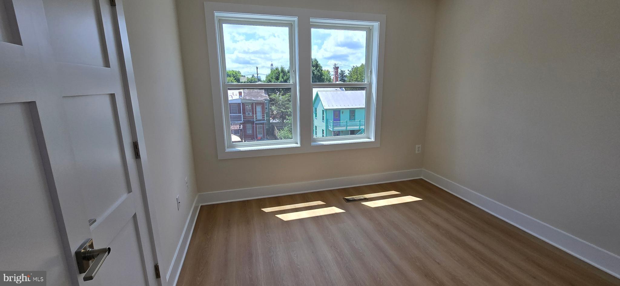 416 Chapel Alley, Unit 3 Frederick, MD 21701 - Photo 28 of 41 a view of empty room with wooden floor and window