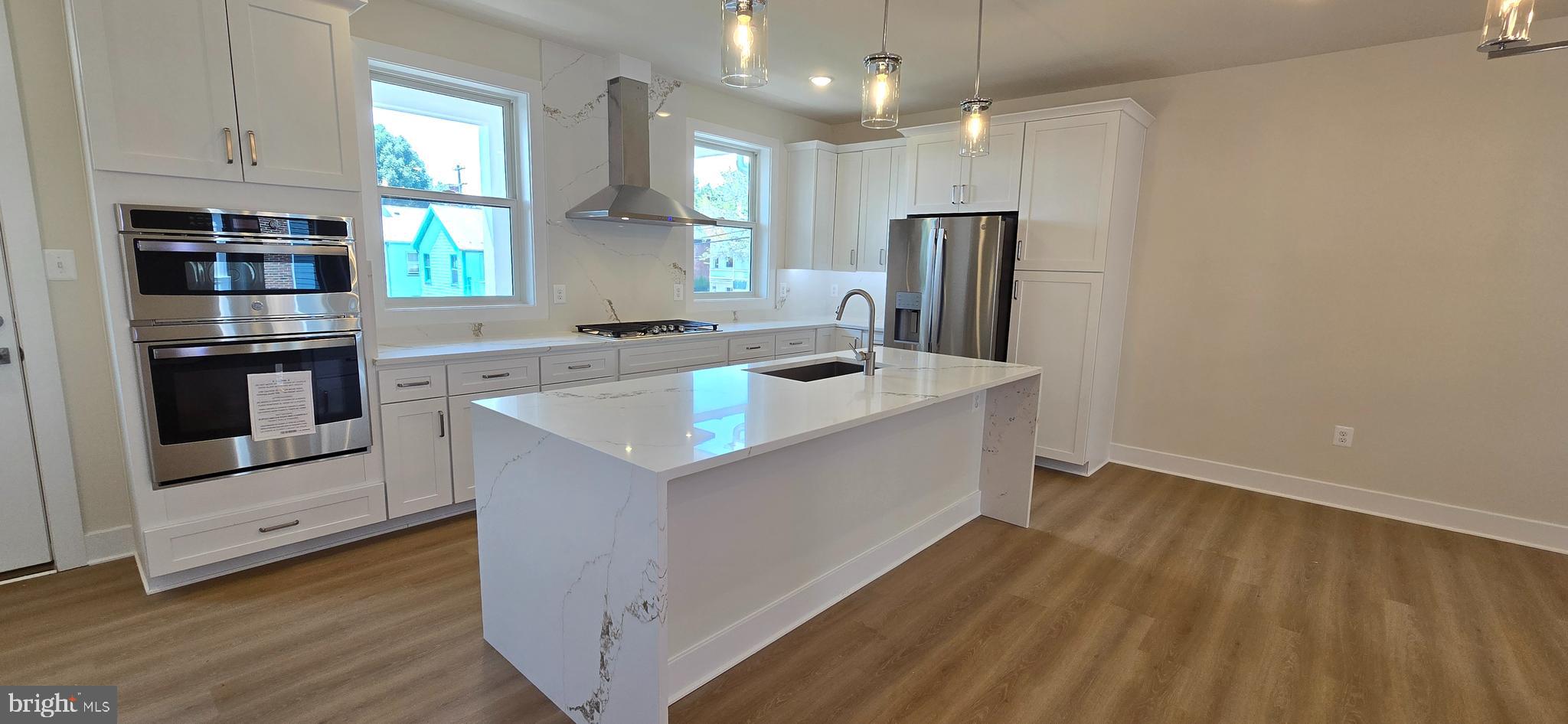 416 Chapel Alley, Unit 3 Frederick, MD 21701 - Photo 3 of 41 a kitchen that has a sink stainless steel appliances counter space and wooden floor