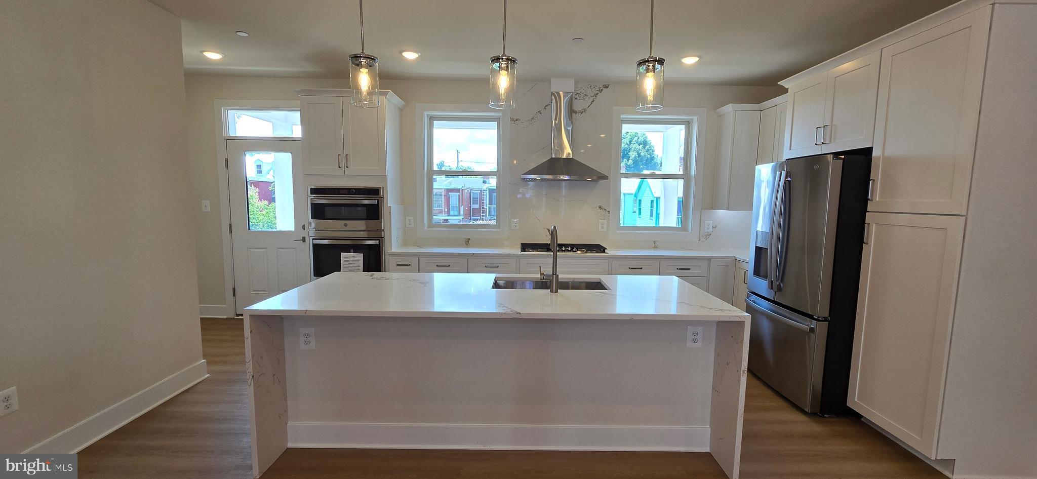 416 Chapel Alley, Unit 3 Frederick, MD 21701 - Photo 9 of 41 a kitchen with kitchen island a refrigerator and a sink
