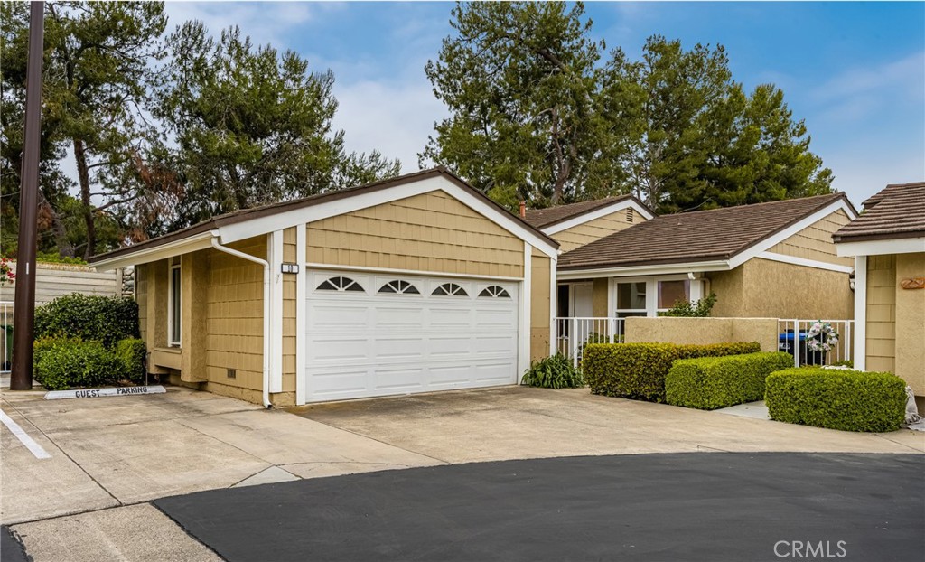 10 Greenbriar, Unit 31 Irvine, CA 92604 - Photo 1 of 46 a front view of a house with a yard and garage