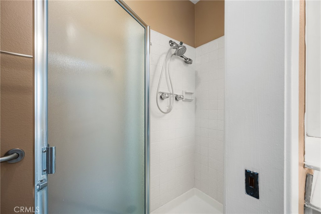 10 Greenbriar, Unit 31 Irvine, CA 92604 - Photo 20 of 46 a bathroom with a glass shower door
