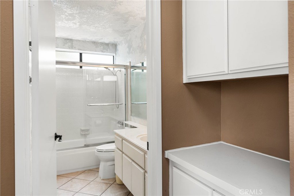 10 Greenbriar, Unit 31 Irvine, CA 92604 - Photo 24 of 46 a bathroom with a granite countertop sink a toilet and shower