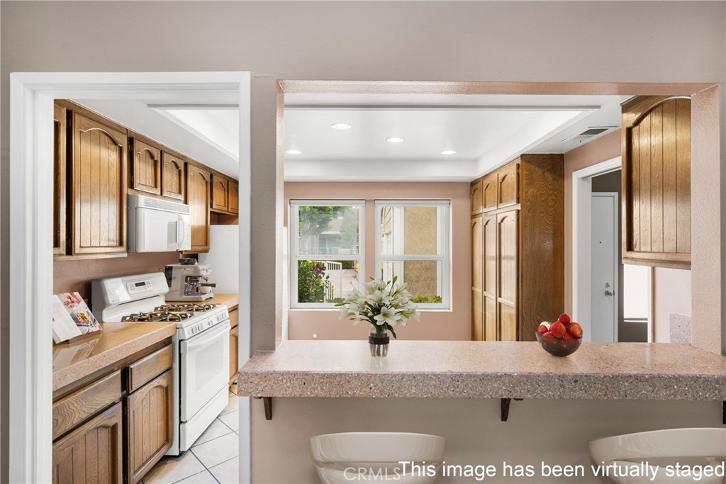 10 Greenbriar, Unit 31 Irvine, CA 92604 - Photo 3 of 46 a kitchen with stainless steel appliances granite countertop sink stove and refrigerator