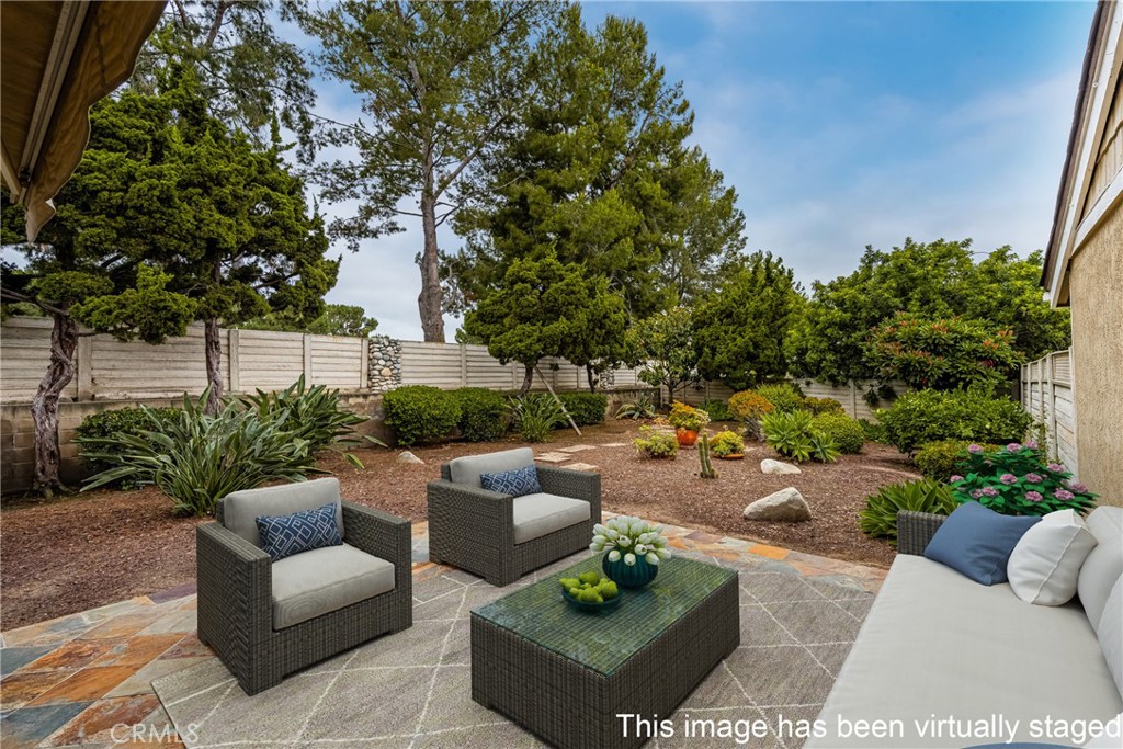 10 Greenbriar, Unit 31 Irvine, CA 92604 - Photo 5 of 46 a view of a patio with couches and a potted plant on a table and chairs