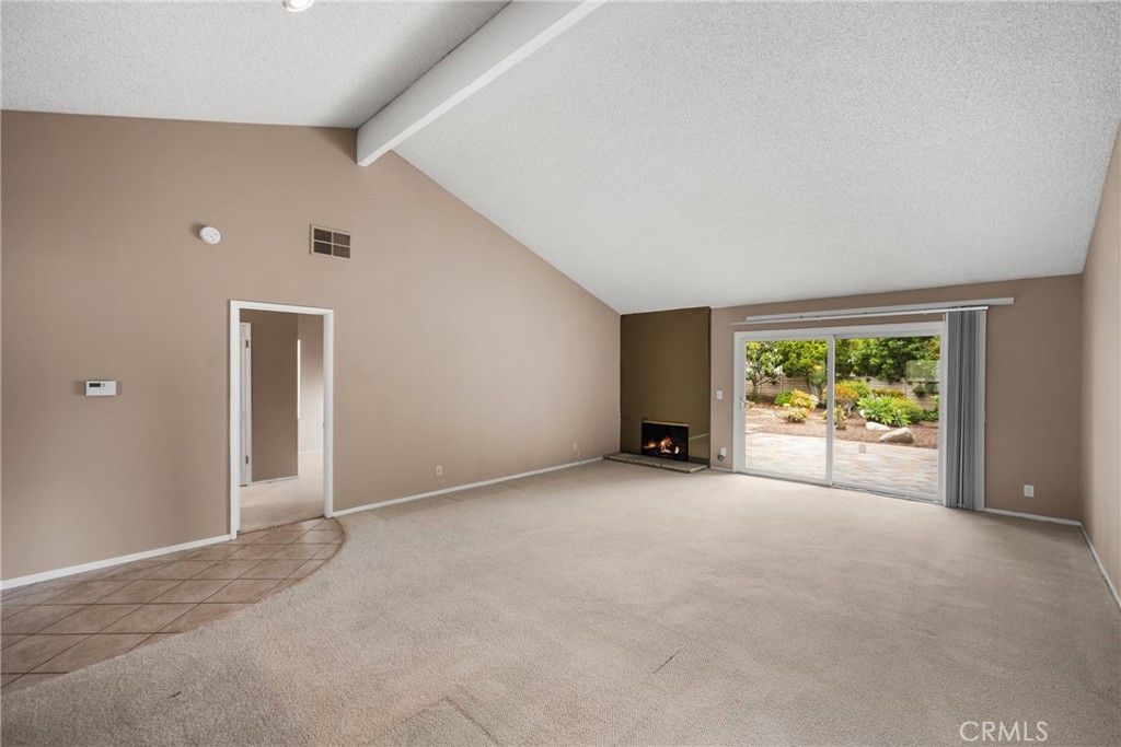 10 Greenbriar, Unit 31 Irvine, CA 92604 - Photo 9 of 46 an empty room with large windows and a yard
