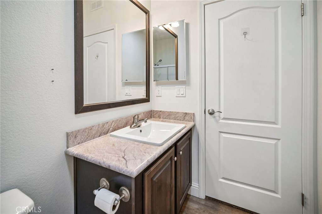 250 East Telegraph Road, Unit 307 Fillmore, CA 93015 - Photo 21 of 36 a bathroom with a granite countertop sink and a mirror