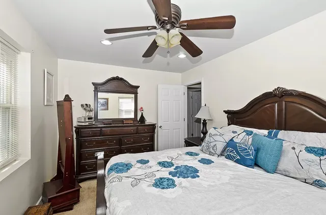 a bedroom with a bed and a dresser