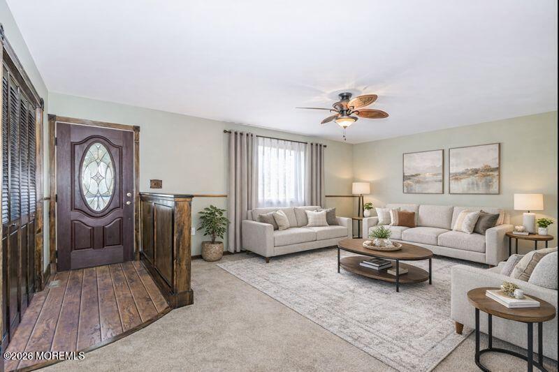 66 Cedar Swamp Road Jackson, NJ 08527 - Photo 3 of 56 a living room with furniture a clock two couches and a large mirror