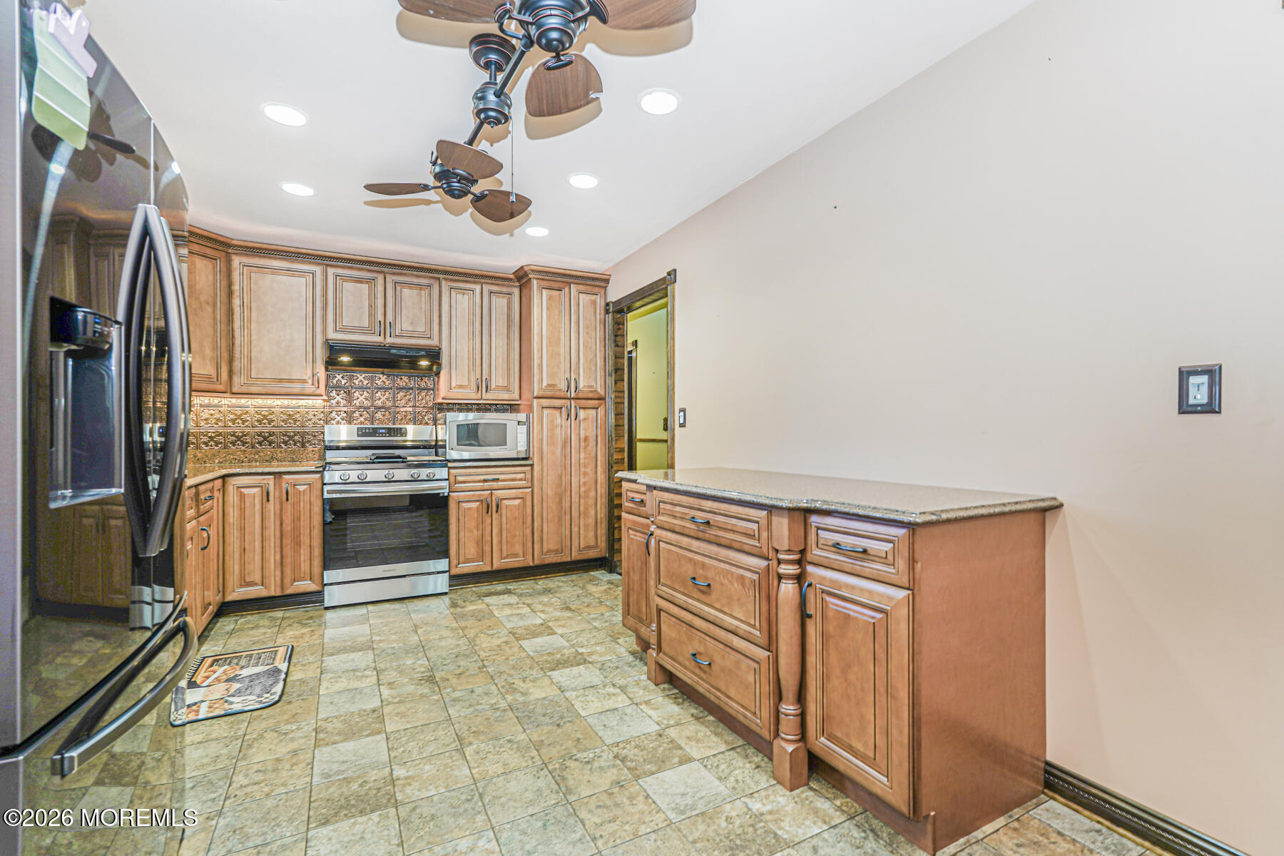 66 Cedar Swamp Road Jackson, NJ 08527 - Photo 46 of 56 a kitchen with granite countertop a refrigerator a stove top oven a sink and dishwasher