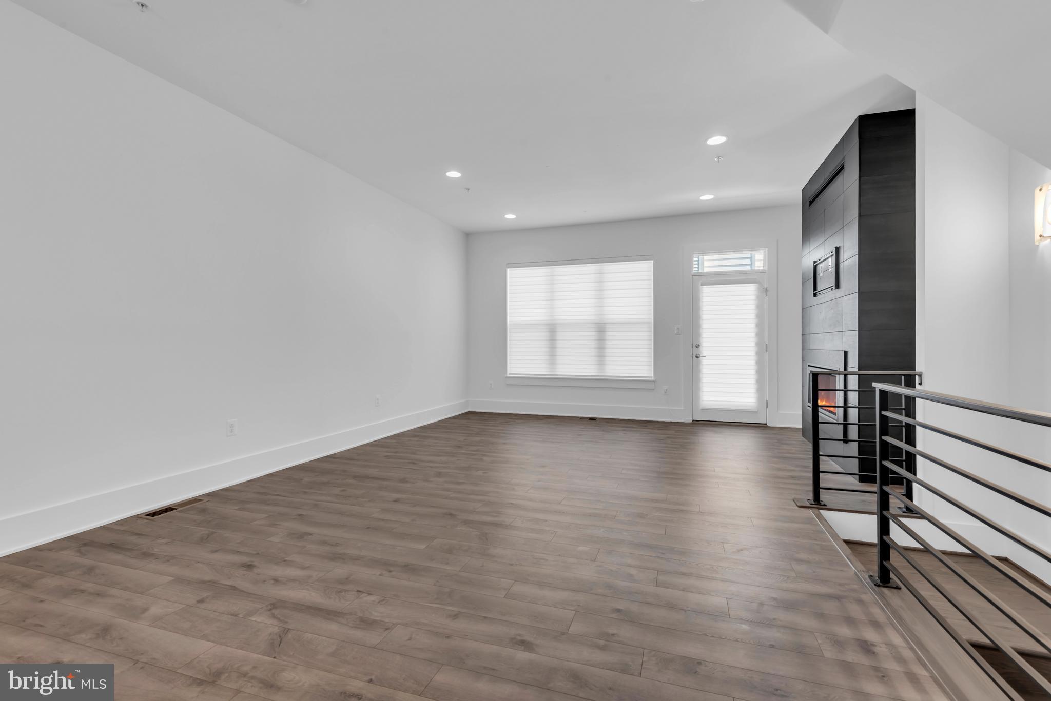 11366 Emerald Park Road Potomac, MD 20854 - Photo 24 of 59 an empty room with wooden floor and windows