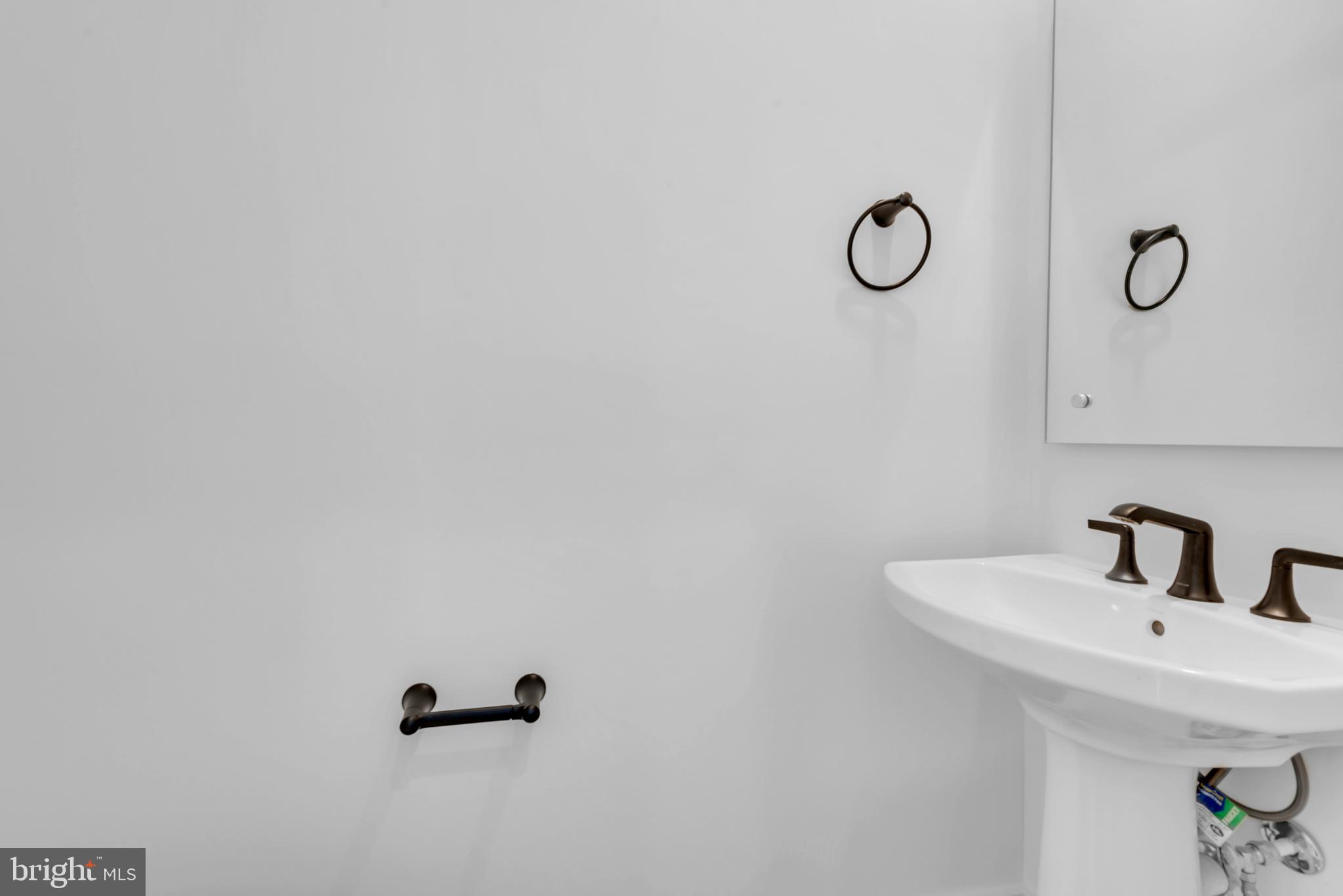 11366 Emerald Park Road Potomac, MD 20854 - Photo 25 of 59 a bathroom with a sink and mirror