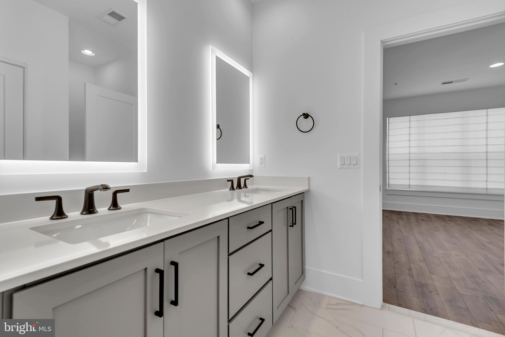 11366 Emerald Park Road Potomac, MD 20854 - Photo 32 of 59 a bathroom with a sink and a mirror