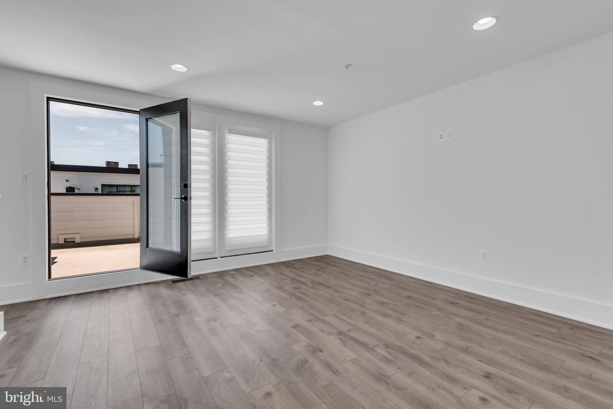 11366 Emerald Park Road Potomac, MD 20854 - Photo 43 of 59 a view of an empty room with a window and wooden floor