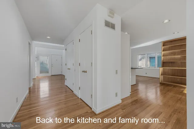 a view of hallway with wooden floor