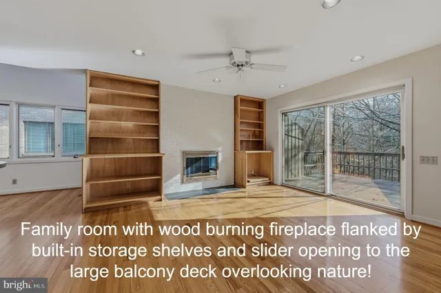 a view of an empty room with a fireplace and a window