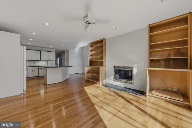 a view of a living room with furniture and a fireplace
