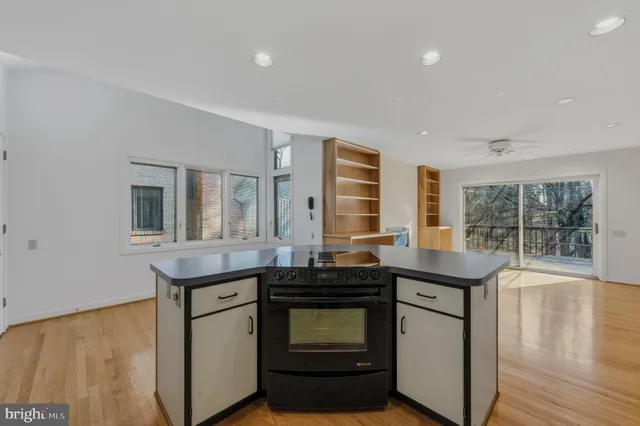 a kitchen with granite countertop a sink and a stove