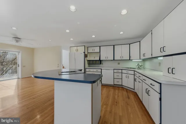 a kitchen with stainless steel appliances granite countertop a sink and cabinets