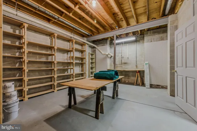a view of a house with brick walls and a yard with plants