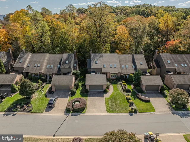 an aerial view of a house with garden space and street view