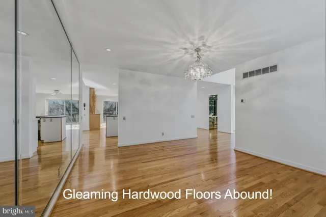 a view of a room with wooden floor