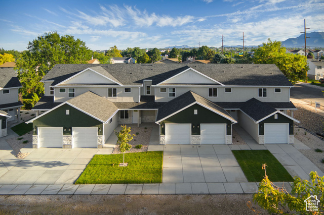1615 North Angel Street, Unit H Layton, UT 84041 - Photo 2 of 55 View of front of house with stone siding, driveway, and a mountain view