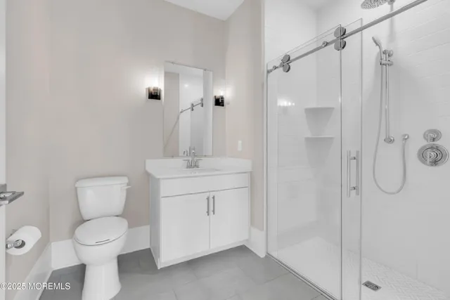 a bathroom with a shower sink and mirror
