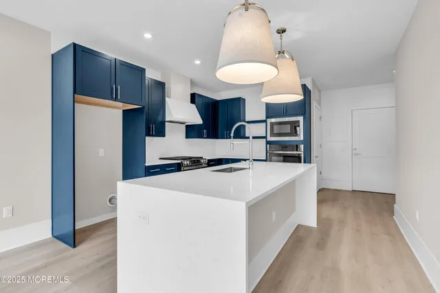 a kitchen with a sink a counter space and a dining table