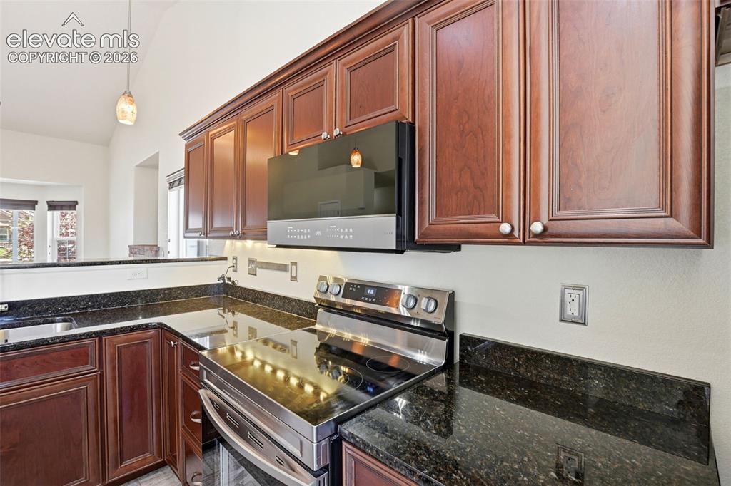 7806 Dutch Loop Colorado Springs, CO 80925 - Photo 9 of 41 a kitchen with a sink and cabinets