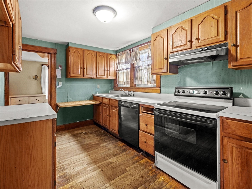 18 Cedar Street Westborough, MA 01581 - Photo 13 of 26 a kitchen with stainless steel appliances granite countertop a sink a stove and a refrigerator